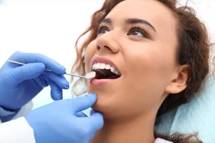 dentist examining woman's teeth, dentist North York, ON