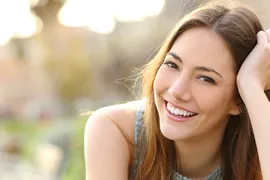 girl outdoors posing and smiling straight teeth Invisalign in Brooklyn, NY