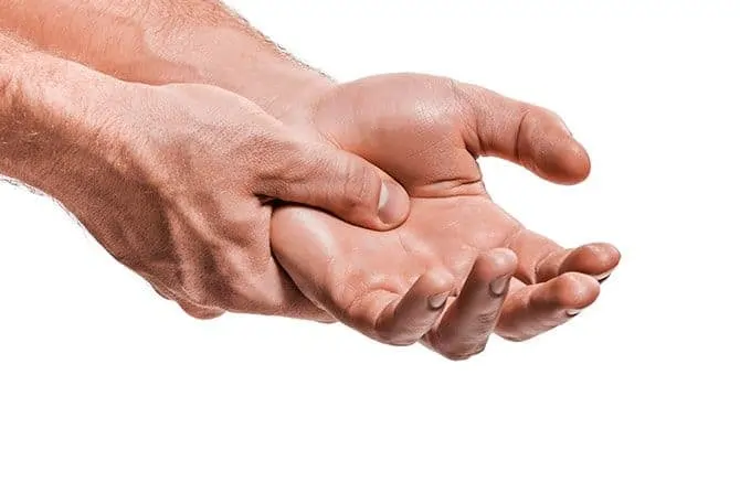 Man with Arthritis holds his hand in pain
