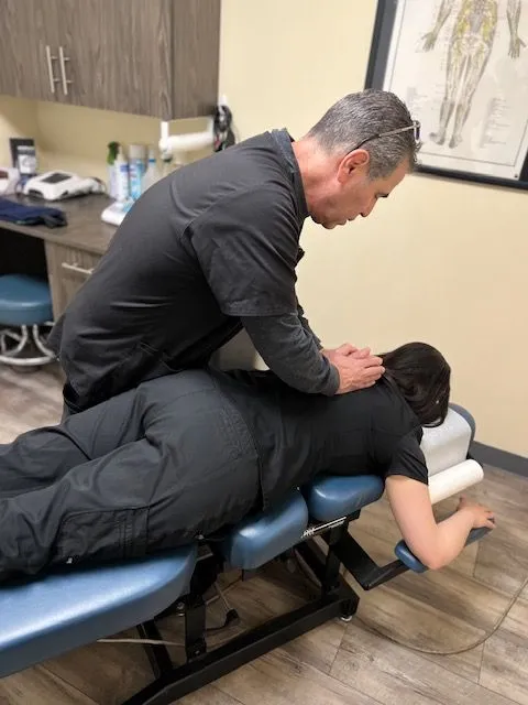 Chiropractor performing an adjustment