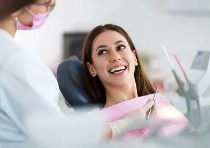 young female dental patient talking to hygienist, dentist Boulder, CO dental sealants