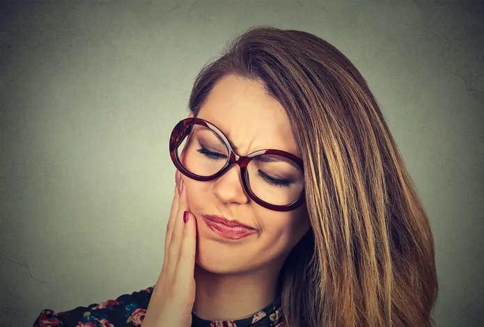 woman holding jaw