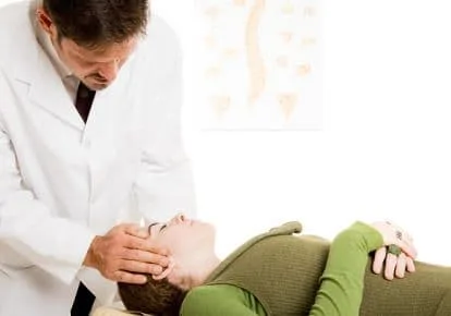 Chiropractor adjusting patient's neck