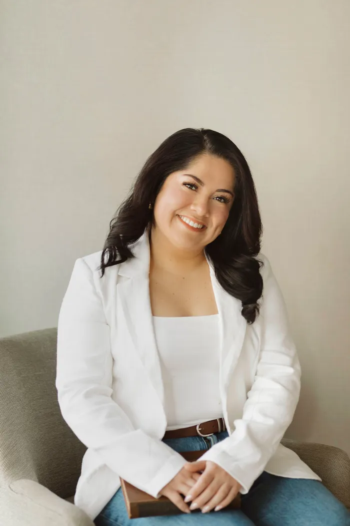 A woman with long black hair and brown eyes.