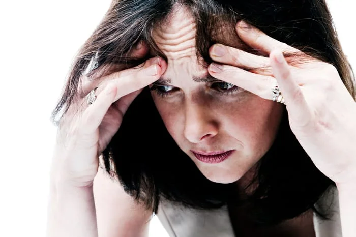 woman feeling anxious with hands on head