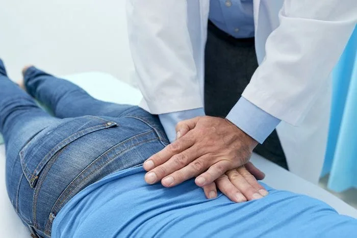 chiropractor adjusting patients back 