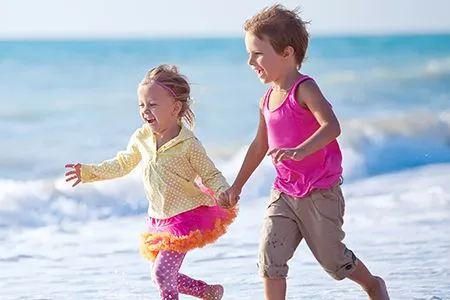 Kids running on beach