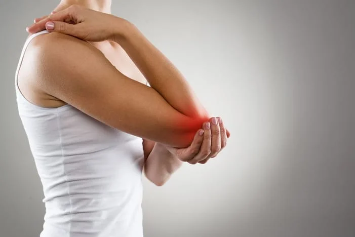 Woman suffering from tennis elbow