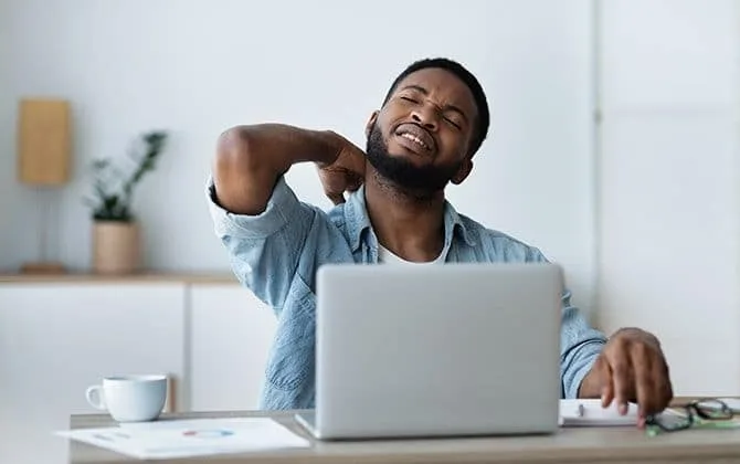 office employee is suffering from severe back pain due to sitting in the office chair for long time 