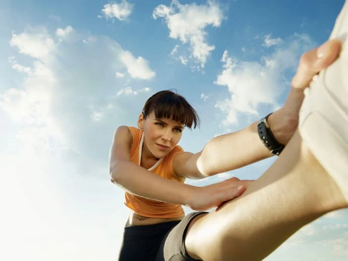 woman stretching her leg