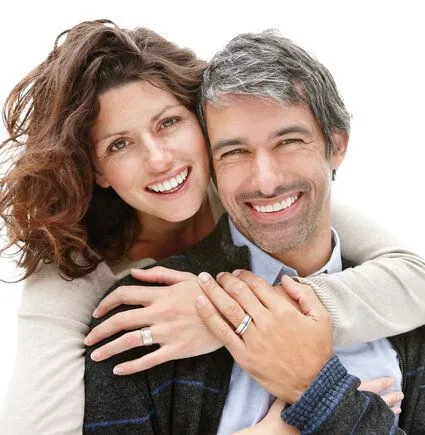 middle aged couple hugging smiling, nice teeth, dental implants Washington DC dentist