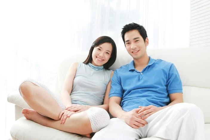 couple sitting on couch waiting for chiropractic care