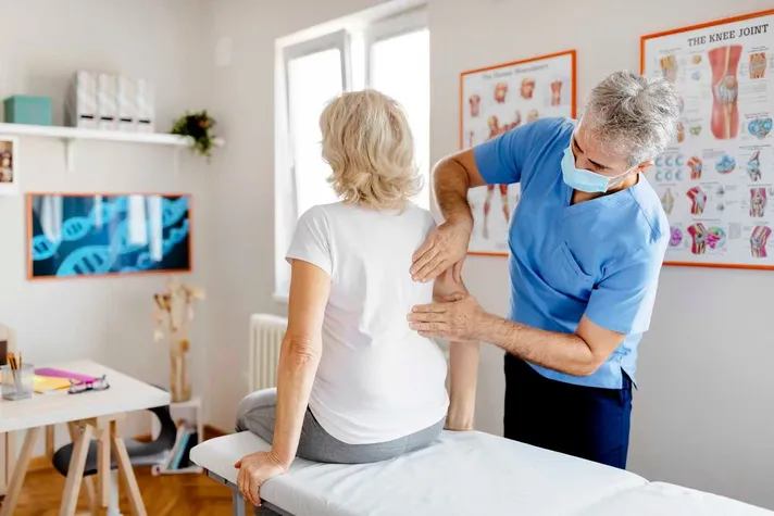 Chiropractor examining a patient's back