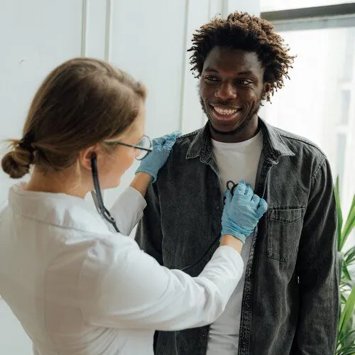 doctor using stethoscope on patient