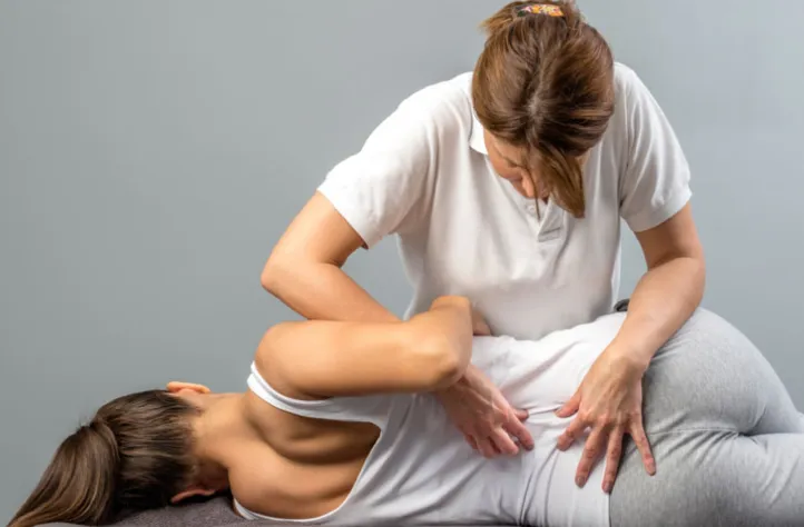 Chiropractor adjusting patient