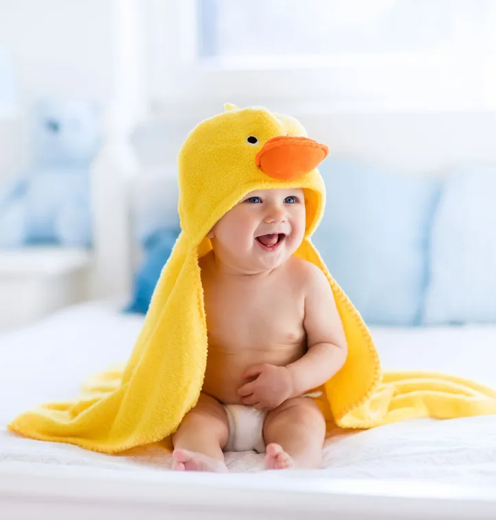 baby wearing yellow duck towel