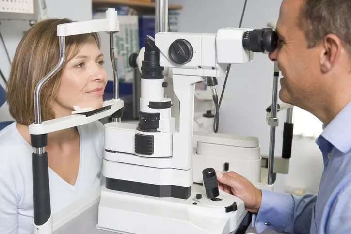 woman receiving an eye exam from her optometrist