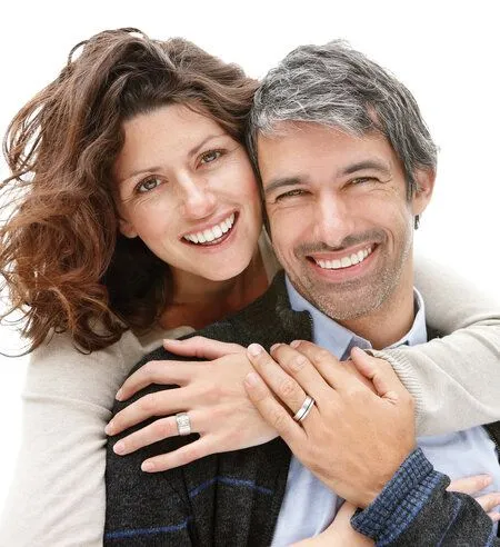 middle aged couple smiling hugging, nice teeth, dental implants Brookline, MA dentist