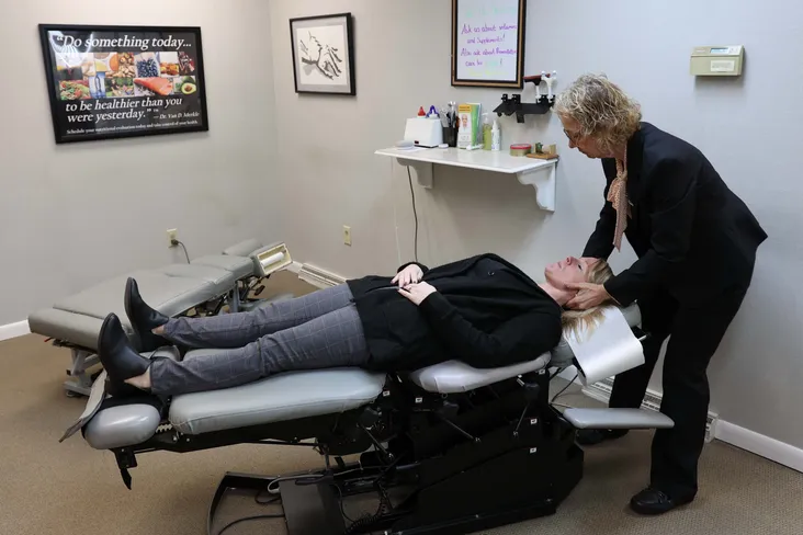 Woman having neck adjustment