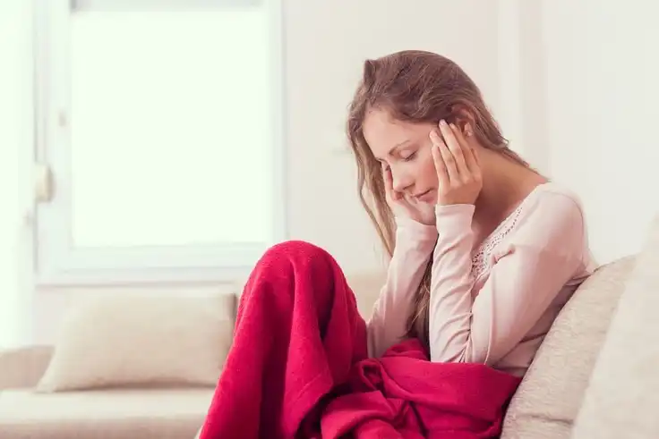 woman with headache treatment in Kenosha sitting on the couch