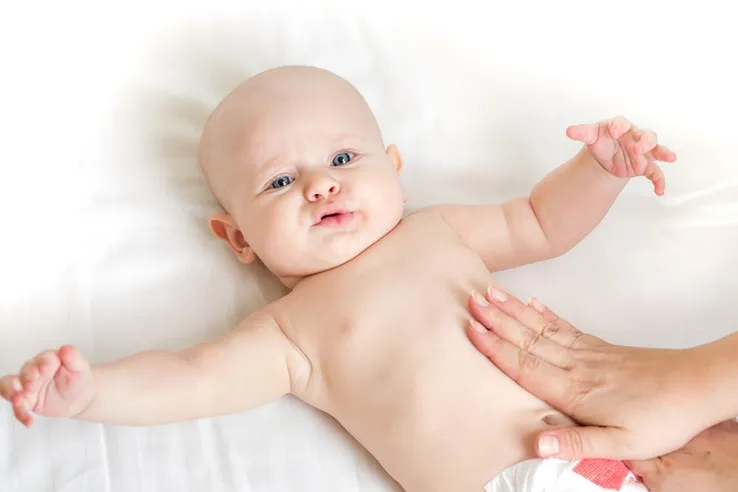 baby receiving a belly massage