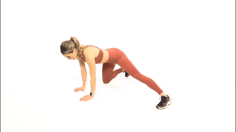 A woman doing the adductor rock back exercise.