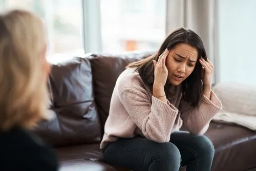 Woman experiencing anxiety during a therapy session