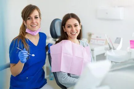 female dental hygienist with female patient in chair, dentist Ottawa, ON general dentistry