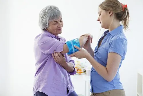 Woman receiving cryotherapy from chiropractor