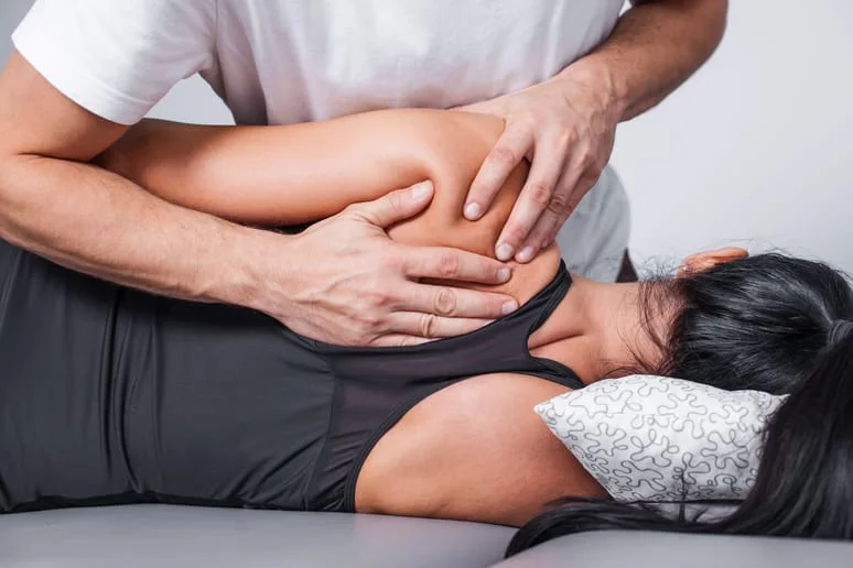 Chiropractor working with patient