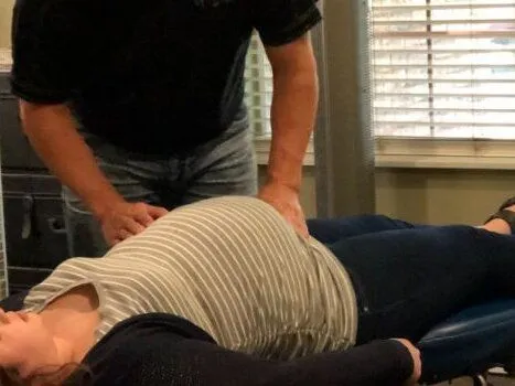 Dr. Wilson adjusting a pregnat lady