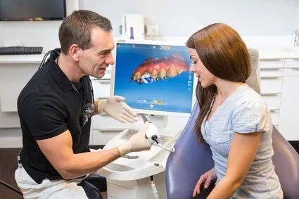 male dentist showing female patient CEREC computer, CEREC crowns Katy, TX dental crowns