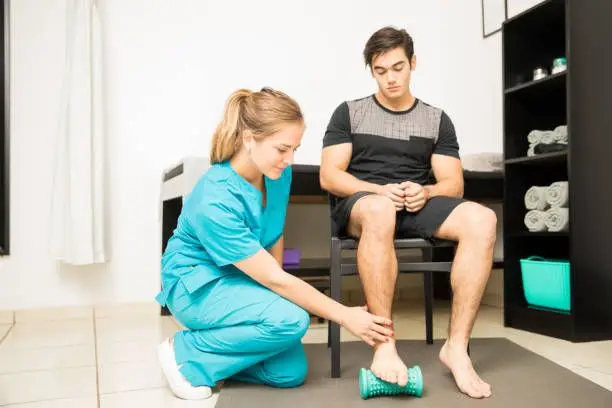 physiotherapist treating plantar fasciitis patient