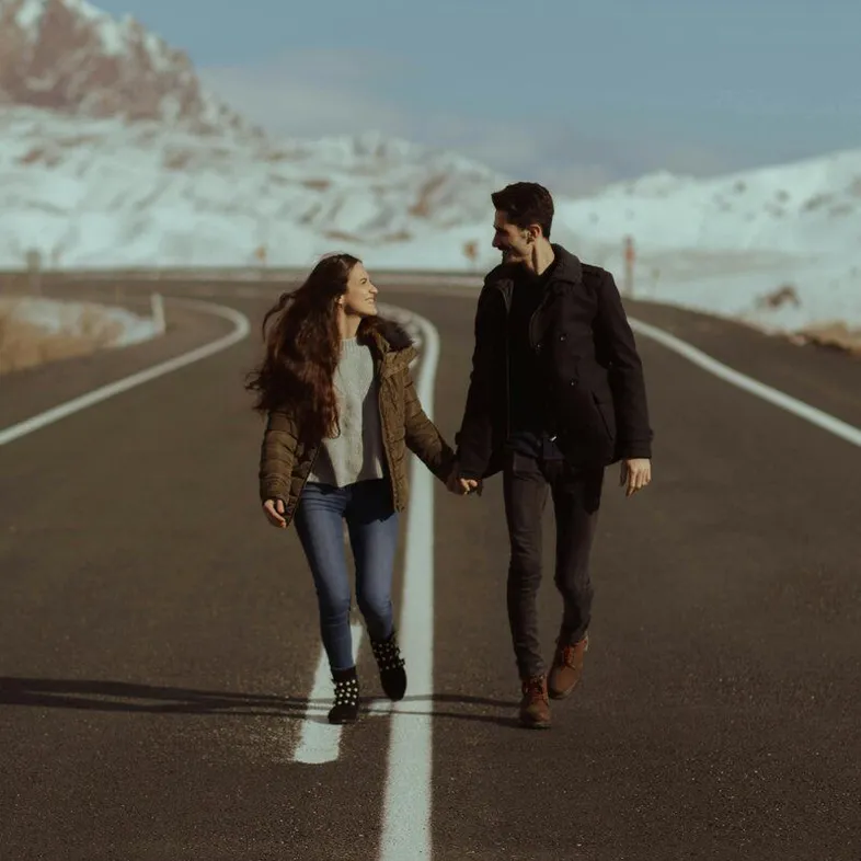 couple walking in the road