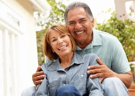 older couple outdoors, smiling and embracing, full and partial dentures Folsom, CA general dentist