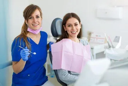 female dentist next to female patient in exam chair, dental exam and teeth cleaning North York dentist