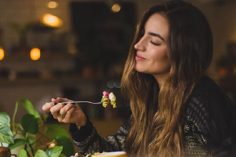 woman enjoying food after recovery from eating disorder