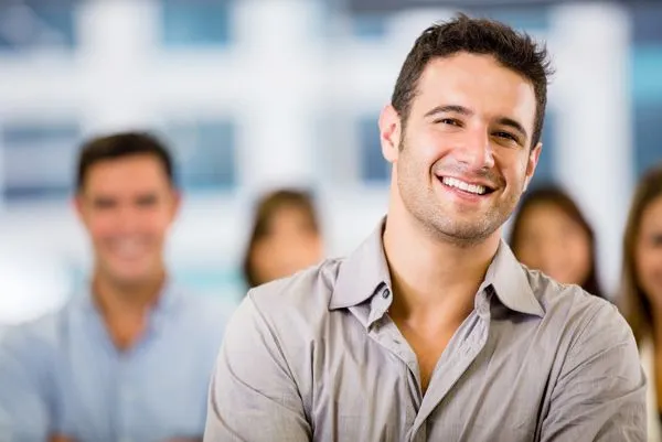 middle aged man smiling nice teeth, other people blurred in background, cosmetic dentistry Gardnerville, NV