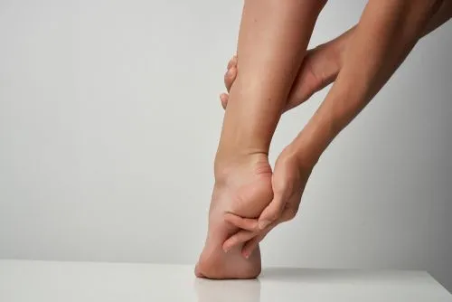 Woman experiencing heel pain from plantar fasciitis