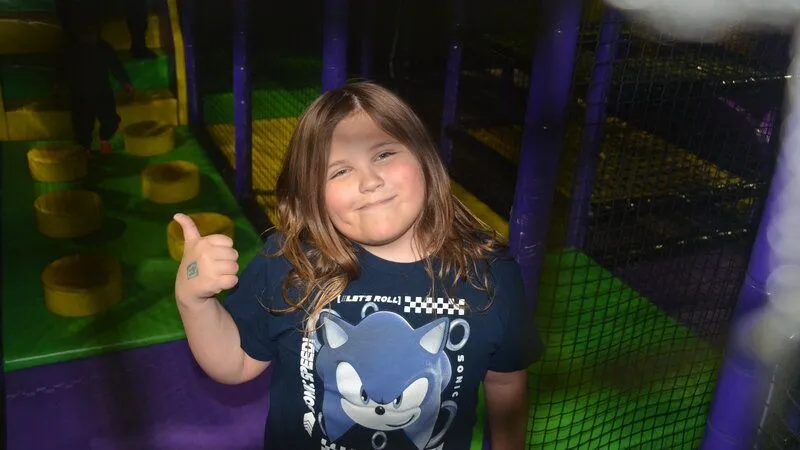 child giving a thumbs up