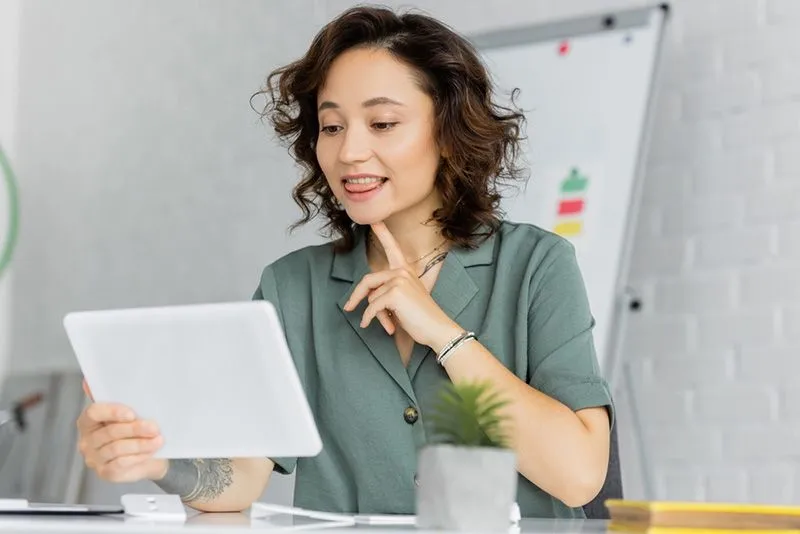 Woman using tablet for assistance speaking