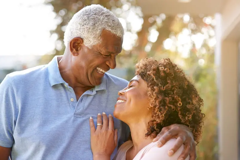 older black couple outdoors, smiling and laughing, dentures Durham, NC dentist