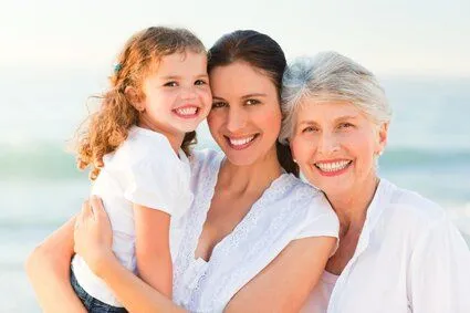 mom with daughter and grandmother on beach smiling, family dentist Peterborough, NH general dentistry