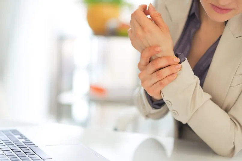 Women holding wrist in pain
