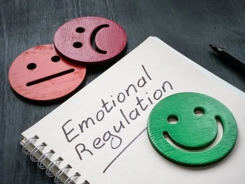 Emotional regulation note with different wooden emotion faces