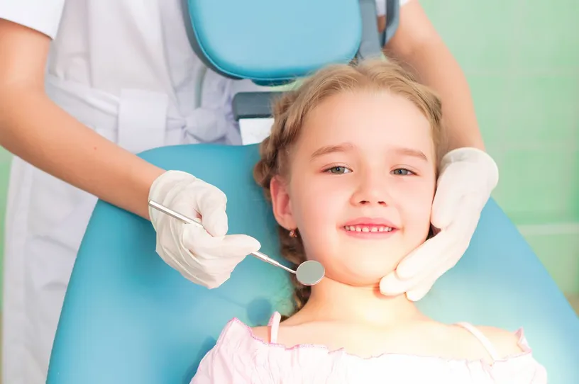 young blond girl sitting in dental chair, children's dentistry Durham, NC dentist