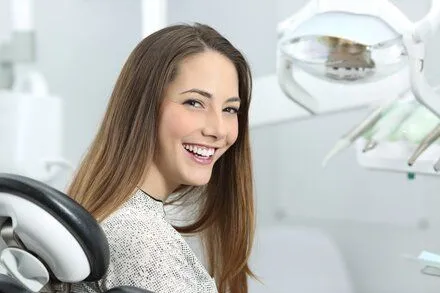 young woman sitting in dental exam chair smiling, dentist in Perry Hall Nottingham, MD cosmetic dentistry