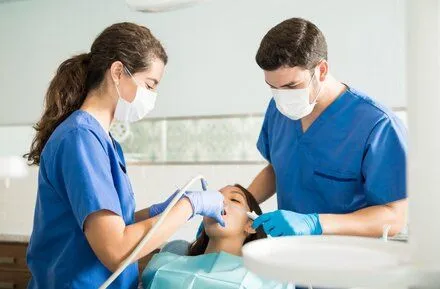 dentist and assistant doing dental work in patient's mouth, general dentistry Rocky River, OH dentist