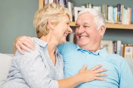 older woman and man looking at each other smiling, nice teeth, dentures Baker City, OR dentist