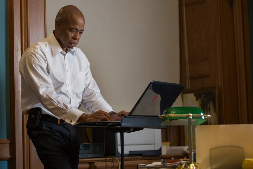 Man standing at desk at work